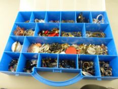 Good compartmented and lidded plastic case with large quantity of mixed dress jewellery