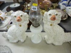 Vintage glass oil lamp and a pair of white Staffs comforter dogs