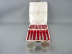 Pair of boxed EP napkin rings and a boxed set of EP cake forks