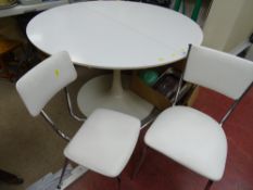 Circular white extending dining table possibly by designer Eero Saarinen and two non-matching chrome