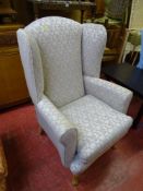 Light patterned classically upholstered wingback chair