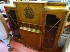 Oak display cabinet with central carved drawer