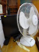 Small screen Samsung LCD TV and a white three speed desk fan E/T