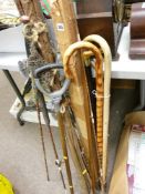 Parcel of well used fishing gear, shooting stick and three walking sticks etc