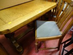 Light oak draw leaf table and four upholstered chairs