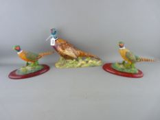 Beswick model of a pheasant no. 1225 along with two colourful resin examples on oval bases