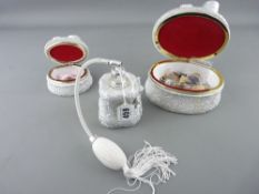 Three piece bow decorated composition dressing table set, two lidded boxes and contents and a