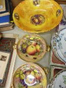 Pair of circular china pedestal fruit bowls with twin gilt handles depicting apples and blackberries