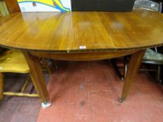 Continental inlaid edge dining table with additional leaf on tapering block supports and brass