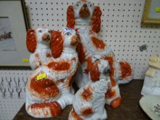 Pair of 19th Century Staffs pottery red and white seated dogs, a single large similar dog and two