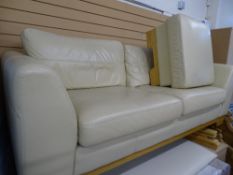 Ultra modern two seater cream leather effect lounge settee and matching footstool