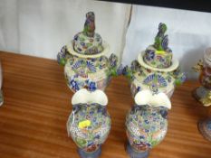 Pair of early 20th Century Satsuma two handled lidded vases and a pair of similar narrow necked