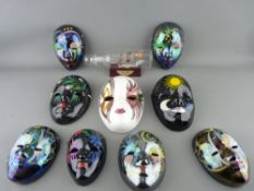 Collection of lustre decorated face masks and a small glass ship in bottle