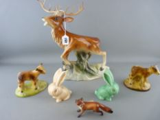 Two Sylvac bunnies, a Jema figurine of a stage, a small Beswick fox and two pottery ornaments of