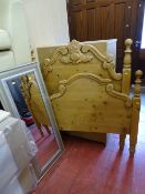 Antique style carved pine single bed frame and a modern framed wall mirror