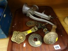 A vintage kitchen mincer together with a heavy elaborate brass door knob & knocker
