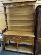 A neat lightwood turn of the century Welsh dresser with open base, three drawers & open rack
