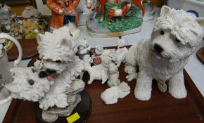A collection of resin West Highland terriers