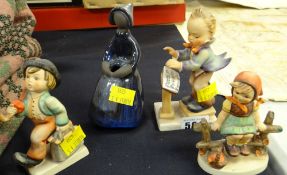 Three Goebel figures together with another