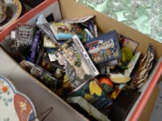 A box containing numerous collectable fridge magnets from various locations around the world