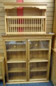 A pine glazed two-door hanging wall cabinet together with a pine plate rack
