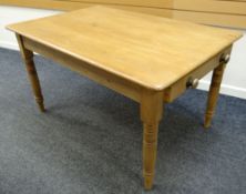 A twentieth century pine farmhouse-type kitchen table with end drawers, raised on turned legs, 137 x