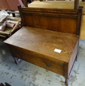 A dark oak hall cabinet with railback