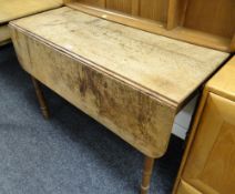 An antique drop flap farmhouse-type table with drawer