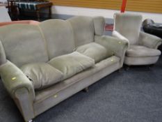 A vintage settee in green upholstery with serpentine back & wing arms on bun feet & a matching
