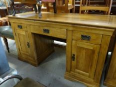 A modern oak pedestal desk with slide out computer table