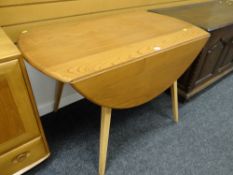 An Ercol blonde drop leaf dining table