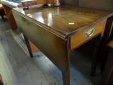 A drop leaf table with drawer