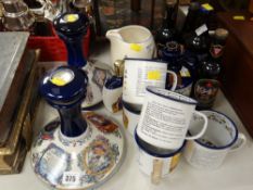 A collection of Wade Pusser's Rum ship's decanters, matching enamel drinking mugs, vintage bottles