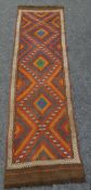 A multi-coloured Suzni Kilim runner, 226 x 61cms