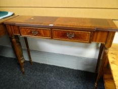 A reproduction mahogany narrow two-drawer console table together with a pair of reproduction
