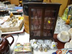 A small glazed display cabinet together with a parcel of child's / doll's teaware & postcards etc