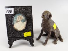 A bronze effect model of a labrador together with a carved wooden Indian picture frame