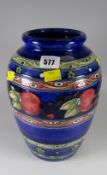 A Moorcroft blue ground & banded vase decorated with fruit