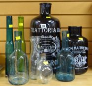 Two large decorative coloured glass advertising bottles together with a small parcel of other