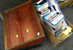 A wooden & glass topped counter display case, small metal case, two boxed multimedia keyboards,