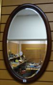 A vintage mahogany & inlaid oval bevelled wall mirror together with two smaller vintage mirrors