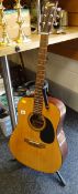 An Encore model EA255 acoustic guitar with stand