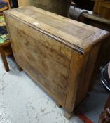 A vintage oak drop flap kitchen table