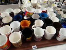 A tray of various special issue various Cadbury's chocolate coffee mugs
