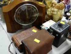 A vintage electric mantel clock together with a parcel of vintage cameras