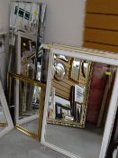 Four modern white painted & gilt bevelled wall mirrors together with a parcel of mirrored panels