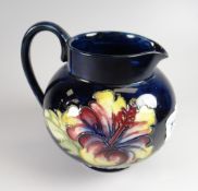 A Moorcroft blue ground & hibiscus decorated jug