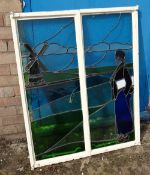 A metal framed window pane with leaded glass depicting a Dutch scene windmill & Dutch woman (