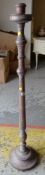 A limed oak floor standing candlestick