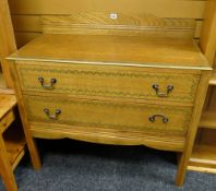 A vintage light oak two-drawer railback chest of drawers with painted decoration